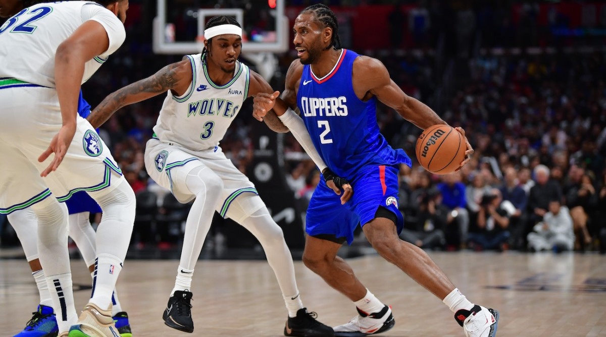 Los Angeles Clippers forward Kawhi Leonard moves the ball against Minnesota Timberwolves forward Jaden McDaniels during the second half at Crypto.com Arena in Los Angeles on Feb. 12, 2024.